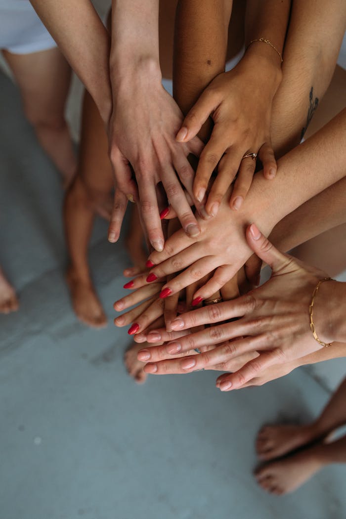 home-img Close-up of diverse hands stacked together symbolizing unity and collaboration.